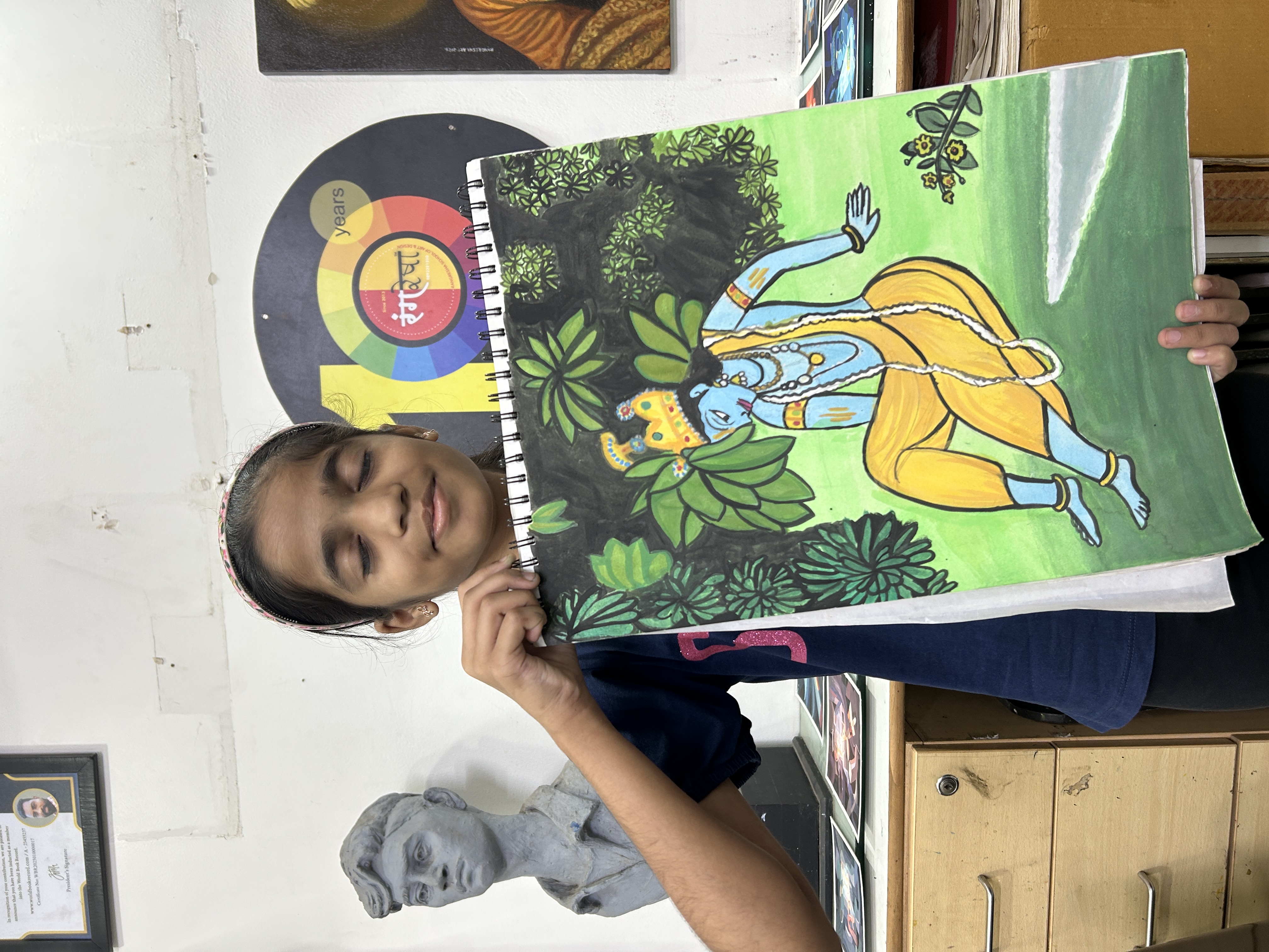 Rangresha student presenting Krishna artwork